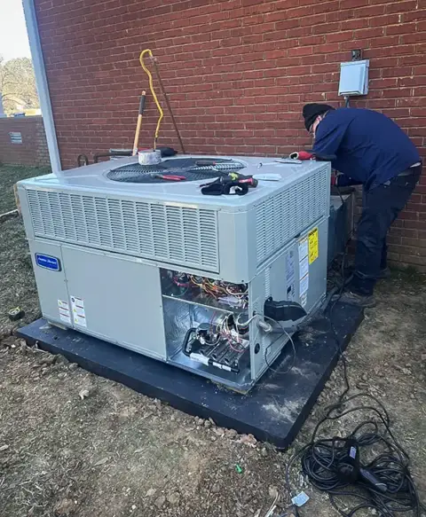 Installing final touches on this HVAC unit.